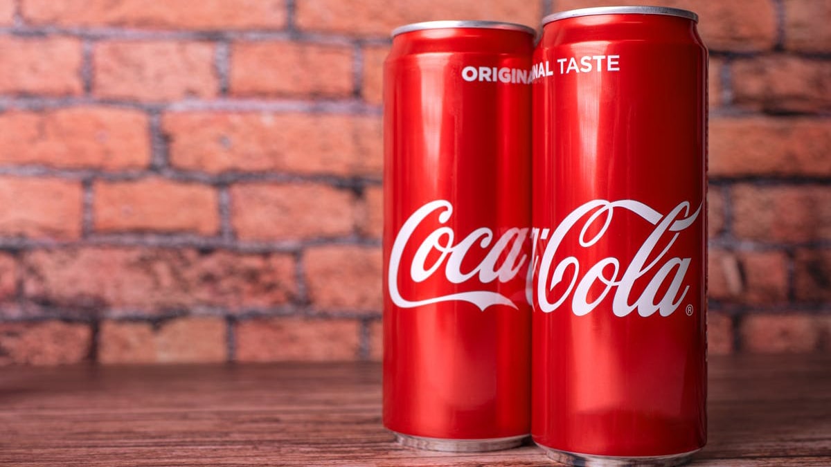 Coca-Cola-cans-on-brick-min