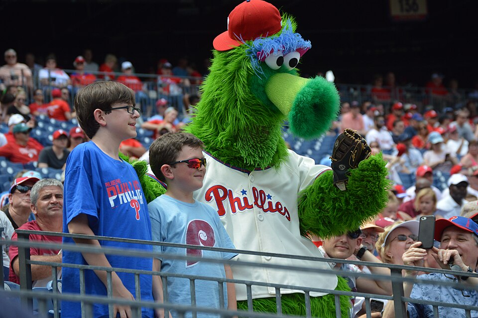 Phillie Phanatic the sport mascot posing with fans in the stands at Citizens Bank Park
